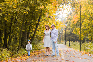 Fototapeta premium Happy family walking in autumn park
