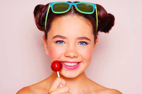 Young Girl With Sunglasses And Lollipop