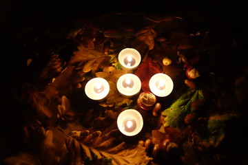 Memorial lights flaming on a grave during All Saints Day