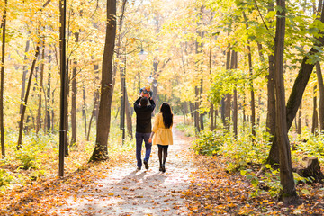Fototapeta premium happy young family with their daughter spending time outdoor in the autumn park