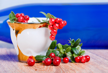 stylish coffee cup and red lingonberries