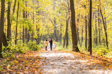 Fototapeta premium love, parenthood, family, season and people concept - smiling couple with baby in autumn park