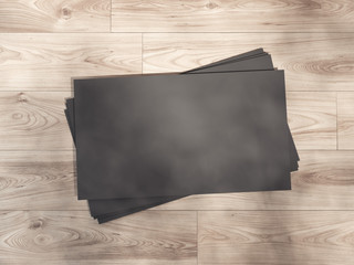 Black business card on a wooden floor. 3d rendering