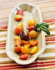 Cherry tomatoes on plate with basil