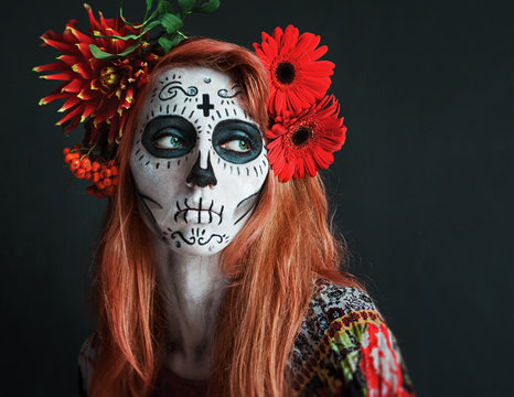 photo portrait of red haired girl with red flowers in her hair makeup Los Muertos