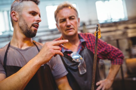 Glassblower interacting with each other in factory