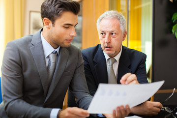 Businessman showing a document to his colleague