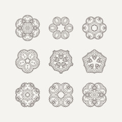 Set of ornate vector mandala symbols. Mehndi lace tattoo. Oriental weave.