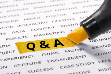 Q & A word highlighted with marker on paper of other related business word.