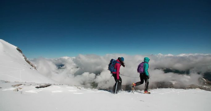 Two women mountaineering above the Clouds