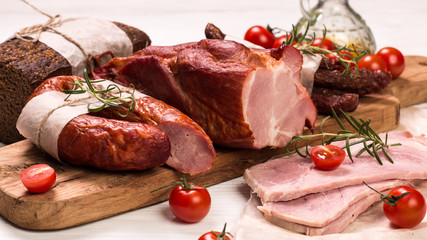 Antipasto catering platter with salami and meat on a wooden background