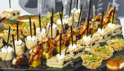 Photo sur Plexiglas Buffet, Bar Catering service . sandwiches meat, fish, vegetable canapes on a festive wedding table outdoor