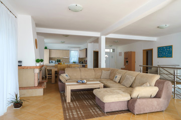 Interior of a living room with kitchen zone in a villa