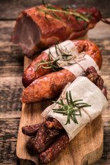 Antipasto catering platter with salami and meat on a wooden background