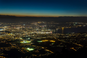 Aerial view of the city of Geneva at night.