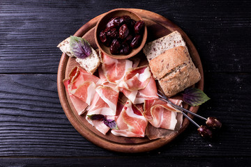 Curled Slices of Delicious Prosciutto with spice  Italian cuisine