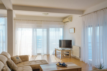 Interior of a living room with kitchen zone in a villa