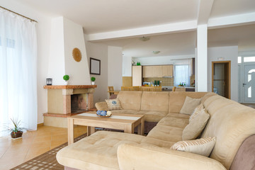 Interior of a living room with kitchen zone in a villa