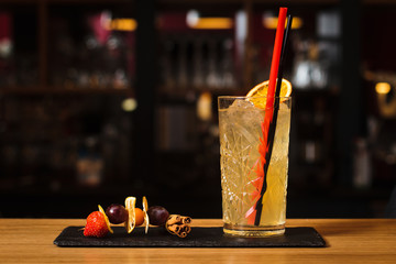 Glass of cocktail on bar background