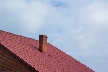 Part of the red-tiled roof of one of the private houses.