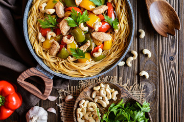 Whole meal spaghetti with chicken meat, pepper and cashew nuts