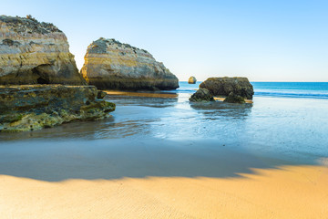 Morning on the beach of Praia da Rocha, Portimao Coast. Algarve region. Portugal