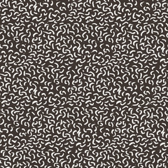 Seamless pattern of abstract strokes and dots.