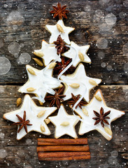 Christmas tree cookie with spices on the old wooden background