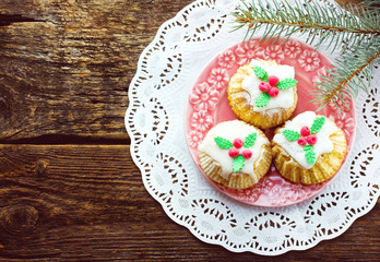 Beautiful Christmas cupcakes on old wooden background