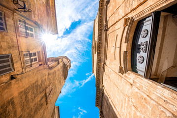 View from below on the church of Holy Espirit on the narrow street in Aix-en-Provence in France