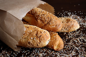 Bread rolls with seeds in a paper bag 

