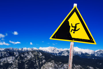 Warning sign - possible fall from the mountain cliff