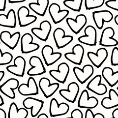Modern seamless pattern with hand painted hearts in black and white