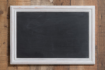 Chalkboard in white wooden distressed frame.