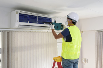 Technician do cleaning investigate Repairing Air Conditioner - 122685683