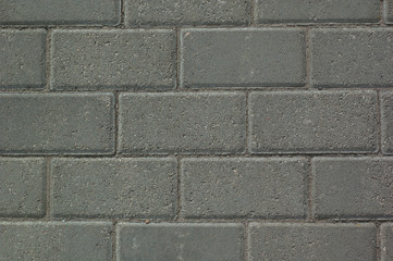 Abstract background: gray paving slabs in the form of bricks.