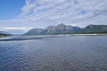Sunny landscape of the river in mountains.