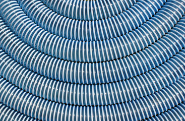 Blue and white corrugated plastic hose as background