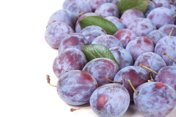 heap of blue plums isolated on a white background