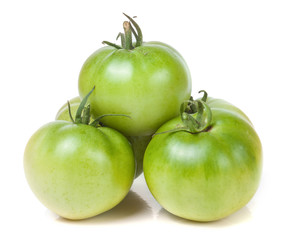 Three green unripe tomato isolated on white background