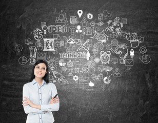 Girl with black hair near blackboard with startup icons