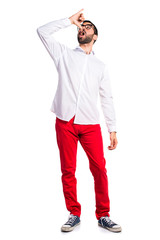 Fototapeta premium Handsome man with glasses doing drunk gesture