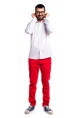 Handsome man with glasses covering his ears