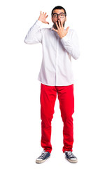 Handsome man with glasses doing surprise gesture