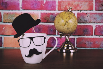 Coffee cup with a black hipster mustache  Vintage Retro Filter.