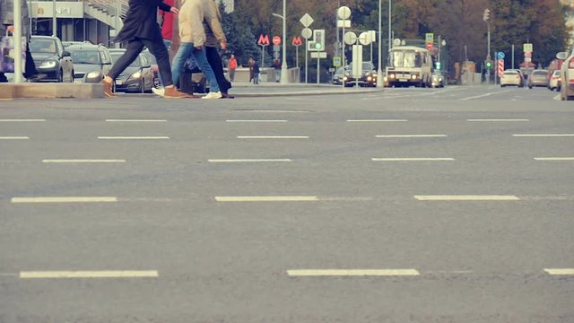 People cross the road at a pedestrian crossing