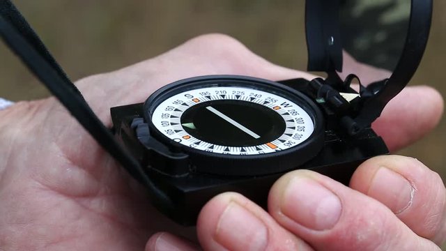 Man holds in hand a compass