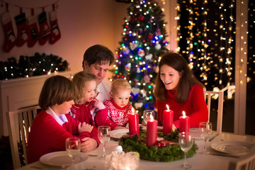Fototapeta na wymiar Family having Christmas dinner at fire place