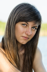 Portrait of a young beautiful girl with a smile and with dark hair