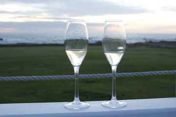 Two glasses of champagne at sunset on an outside terrace